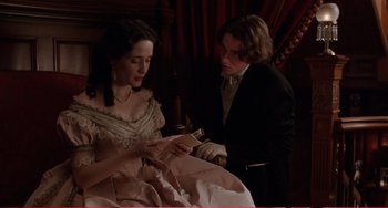 Movie still from “Little Women” (1994), directed by Gillian Armstrong – A man and a woman are looking at a book; Medium shot, Over the shoulder angle