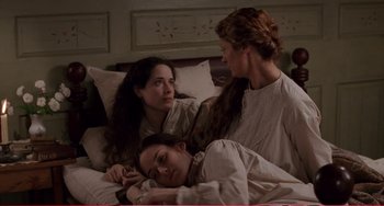 Movie still from “Little Women” (1994), directed by Gillian Armstrong – Three women are laying in bed and one woman is sleeping; Medium shot, High angle
