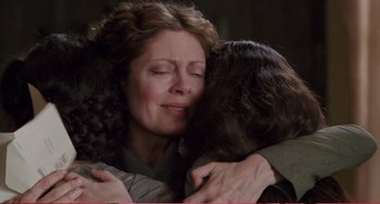 Movie still from “Little Women” (1994), directed by Gillian Armstrong – Two people hugging each other in a dark room; Close Up shot, Over the shoulder angle