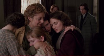 Movie still from “Little Women” (1994), directed by Gillian Armstrong – A group of people hugging each other in a room; Medium shot, Over the shoulder angle