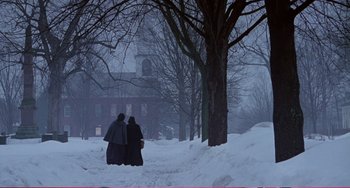 Movie still from “Little Women” (1994), directed by Gillian Armstrong – Two people standing in the middle of a snow covered park; Extreme Wide shot, Low angle