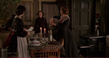 Movie still from “Little Women” (1994), directed by Gillian Armstrong – A woman pouring wine into a pitcher at a dinner table; Medium shot, High angle