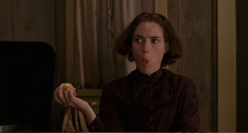 Movie still from “Little Women” (1994), directed by Gillian Armstrong – A woman holding an apple in her hand; Close Up shot, Over the shoulder angle
