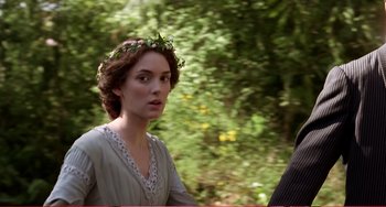 Movie still from “Little Women” (1994), directed by Gillian Armstrong – A young woman wearing a flower crown in a wooded area; Close Up shot, Over the shoulder angle