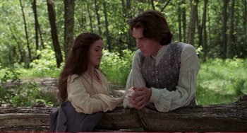 Movie still from “Little Women” (1994), directed by Gillian Armstrong – A man and a woman sitting next to each other on the ground; Medium shot, Over the shoulder angle