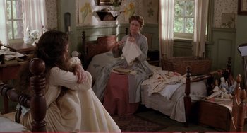 Movie still from “Little Women” (1994), directed by Gillian Armstrong – Two women sitting on a bed talking to each other; Wide shot, High angle