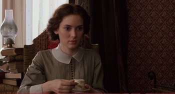 Movie still from “Little Women” (1994), directed by Gillian Armstrong – A woman sitting in a chair holding a coffee cup; Close Up shot, High angle
