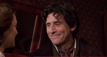 Movie still from “Little Women” (1994), directed by Gillian Armstrong – A person wearing a suit and tie; Close Up shot, Over the shoulder angle