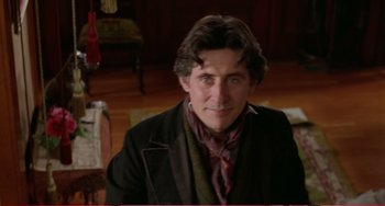 Movie still from “Little Women” (1994), directed by Gillian Armstrong – A person wearing a suit and tie; Close Up shot, Over the shoulder angle