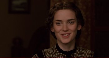 Movie still from “Little Women” (1994), directed by Gillian Armstrong – A young woman smiles for the camera; Close Up shot, Over the shoulder angle
