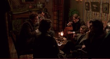 Movie still from “Little Women” (1994), directed by Gillian Armstrong – A group of people sitting around a living room; Wide shot, High angle