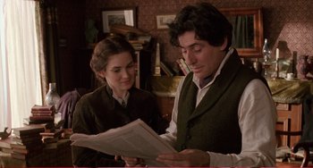 Movie still from “Little Women” (1994), directed by Gillian Armstrong – A man and a woman are looking at a newspaper; Medium shot, Over the shoulder angle