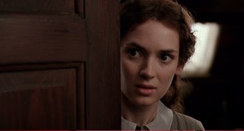 Movie still from “Little Women” (1994), directed by Gillian Armstrong – A person standing in front of a door; Close Up shot, Over the shoulder angle