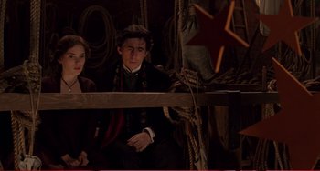 Movie still from “Little Women” (1994), directed by Gillian Armstrong – A man and a woman sitting next to each other; Medium shot, Low angle