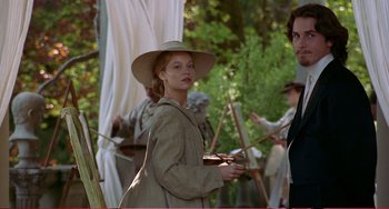 Movie still from “Little Women” (1994), directed by Gillian Armstrong – A woman in a hat standing next to a man in a hat; Medium shot, Low angle