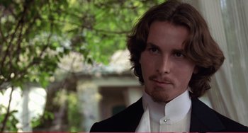 Movie still from “Little Women” (1994), directed by Gillian Armstrong – A person wearing a suit and tie; Close Up shot, Over the shoulder angle