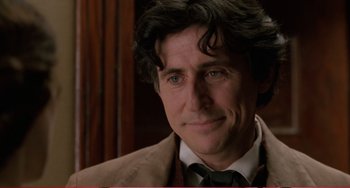 Movie still from “Little Women” (1994), directed by Gillian Armstrong – A person wearing a suit and tie; Close Up shot, Over the shoulder angle