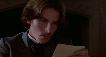 Movie still from “Little Women” (1994), directed by Gillian Armstrong – A man in a suit looking down at a piece of paper; Close Up shot, Low angle