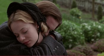 Movie still from “Little Women” (1994), directed by Gillian Armstrong – A woman is leaning on a man's shoulder while holding her head down; Close Up shot, Low angle