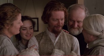 Movie still from “Little Women” (1994), directed by Gillian Armstrong – A man and a woman standing next to another man; Medium shot, Over the shoulder angle