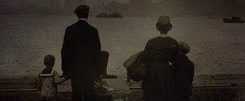 Movie still from “Live by Night” (2016), directed by Ben Affleck – A man and a woman looking out over a body of water; Wide shot, High angle