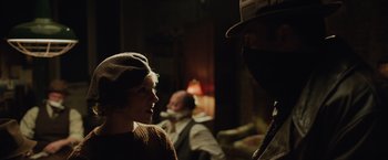 Movie still from “Live by Night” (2016), directed by Ben Affleck – A man and a woman are talking in a living room; Close Up shot, Over the shoulder angle