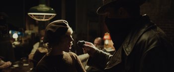Movie still from “Live by Night” (2016), directed by Ben Affleck – A man holding a microphone up to a woman's face; Close Up shot, Over the shoulder angle