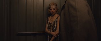 Movie still from “Live by Night” (2016), directed by Ben Affleck – A woman wearing a dress and a head piece; Medium shot, Low angle