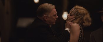 Movie still from “Live by Night” (2016), directed by Ben Affleck – An older man touching the face of a young woman; Close Up shot, Over the shoulder angle