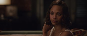 Movie still from “Live by Night” (2016), directed by Ben Affleck – A person sitting on a couch; Close Up shot, Over the shoulder angle