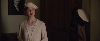 Movie still from “Live by Night” (2016), directed by Ben Affleck – A woman in a white dress and a white hat; Close Up shot, Over the shoulder angle