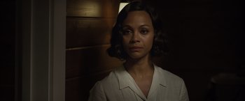 Movie still from “Live by Night” (2016), directed by Ben Affleck – A woman in a white shirt is looking at the camera; Close Up shot, Over the shoulder angle