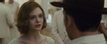 Movie still from “Live by Night” (2016), directed by Ben Affleck – A woman in a white dress looking at a man in a white suit; Close Up shot, Over the shoulder angle