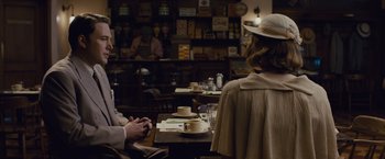 Movie still from “Live by Night” (2016), directed by Ben Affleck – Two people sitting at a table with cups of coffee; Medium shot, Over the shoulder angle