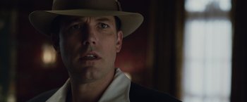 Movie still from “Live by Night” (2016), directed by Ben Affleck – A person wearing a hat; Close Up shot, Low angle