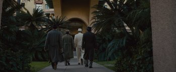 Movie still from “Live by Night” (2016), directed by Ben Affleck – A group of people walking down a sidewalk; Wide shot, Low angle