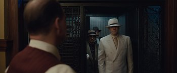 Movie still from “Live by Night” (2016), directed by Ben Affleck – A group of men standing next to each other in suits; Medium shot, Low angle