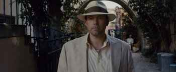 Movie still from “Live by Night” (2016), directed by Ben Affleck – A man wearing a hat and a suit; Close Up shot, Low angle