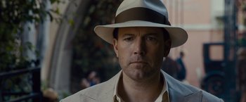 Movie still from “Live by Night” (2016), directed by Ben Affleck – A person wearing a hat; Close Up shot, Low angle