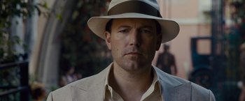 Movie still from “Live by Night” (2016), directed by Ben Affleck – A person wearing a hat; Close Up shot, Low angle