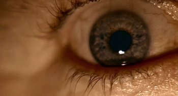 Movie still from “Lock, Stock and Two Smoking Barrels” (1998), directed by Guy Ritchie – A person's eye with the reflection of the sun in the eye; Extreme Close Up shot, Overhead angle
