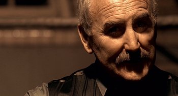 Movie still from “Lock, Stock and Two Smoking Barrels” (1998), directed by Guy Ritchie – An older man with a mustache and a mustache comb; Close Up shot, Low angle