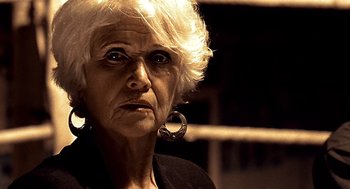 Movie still from “Lock, Stock and Two Smoking Barrels” (1998), directed by Guy Ritchie – An older woman with a strange look on her face; Close Up shot, Low angle