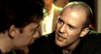 Movie still from “Lock, Stock and Two Smoking Barrels” (1998), directed by Guy Ritchie – A person talking to another person; Close Up shot, Over the shoulder angle