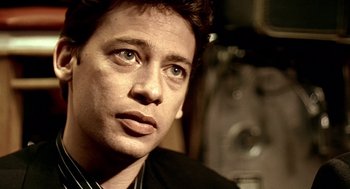 Movie still from “Lock, Stock and Two Smoking Barrels” (1998), directed by Guy Ritchie – A person looking at the camera; Close Up shot, Low angle