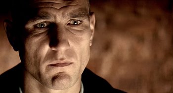 Movie still from “Lock, Stock and Two Smoking Barrels” (1998), directed by Guy Ritchie – A man's face in a black shirt; Extreme Close Up shot, Low angle