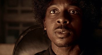 Movie still from “Lock, Stock and Two Smoking Barrels” (1998), directed by Guy Ritchie – A person looking up at the sky; Close Up shot, Low angle