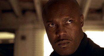 Movie still from “Lock, Stock and Two Smoking Barrels” (1998), directed by Guy Ritchie – A man's eyes and face; Close Up shot, Low angle