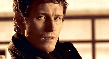 Movie still from “Lock, Stock and Two Smoking Barrels” (1998), directed by Guy Ritchie – A person wearing a suit and tie; Close Up shot, Low angle