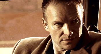 Movie still from “Lock, Stock and Two Smoking Barrels” (1998), directed by Guy Ritchie – A person wearing a suit and tie; Close Up shot, Low angle